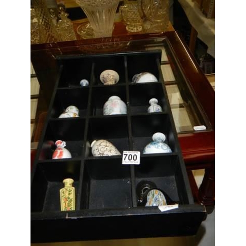 700 - A small display case with eleven minaiture Chinese style vases.