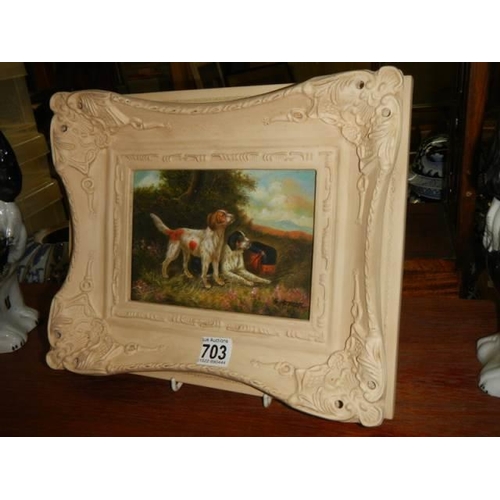 703 - A gilt framed over painted print of dogs.