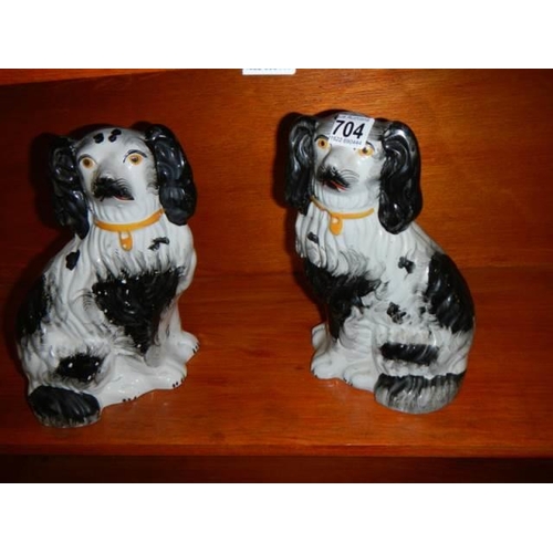 704 - A pair of mid 20th century Staffordshire spaniels.