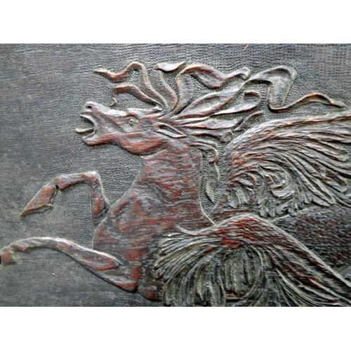 725 - A carved wood panel featuring a horse,.