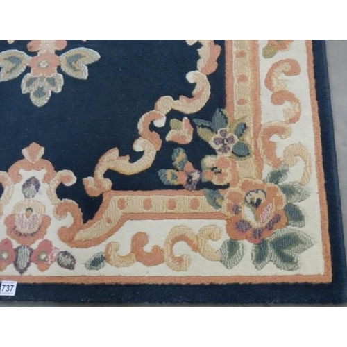 737 - A blue patterned rug, 170 x 120 cm.