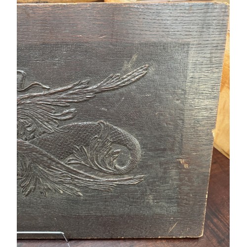 725 - A carved wood panel featuring a horse,.