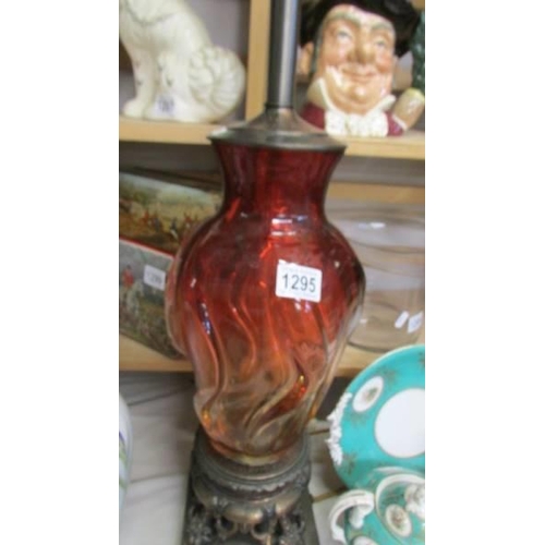 1295 - A tall red glass table lamp on metal base, will need re-wiring, COLLECT ONLY.