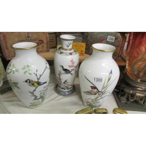 1300 - A pair of vases and one other all hand painted with birds.