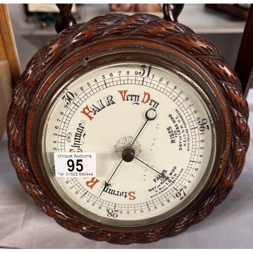 95 - An oak barometer with rope twist case & porcelain dial & A pair of 1930s oak candlesticks