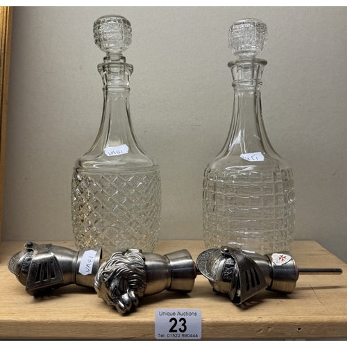 23 - 2 Moulded glass decanters & 3 novelty metal bottle stopper pourers including 2 knights & 1 lion