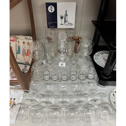 51 - A quantity of Wine & brandy glasses, 2 decanters, boxed cheese cutters etc