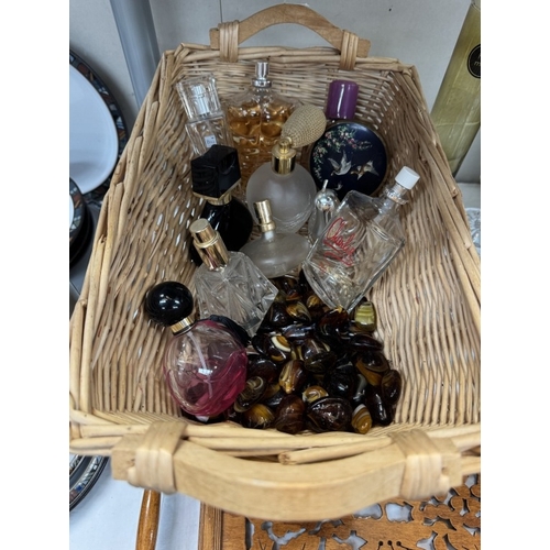 58 - A basket of perfume bottles, mostly empty. 2 Lotus candleholders etc