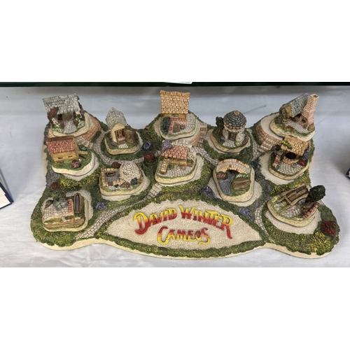 144 - A David Winter Diorama with 12 boxed models, 4 of which are signed