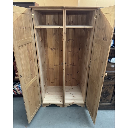 277 - A pair of narrow solid pine wardrobes