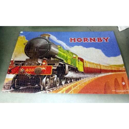 371 - A quantity of old train puzzles glued onto card