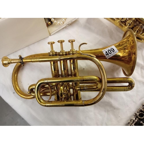 409 - A smaller version of a brass trumpet