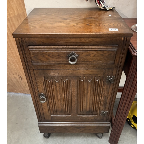 701 - An oak cabinet with linenfold door. COLLECT ONLY.