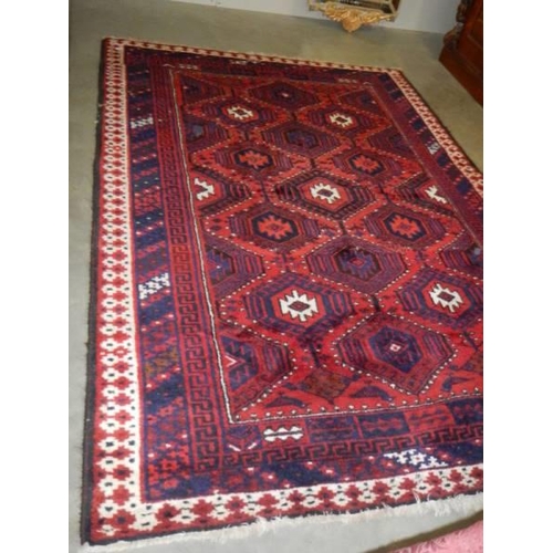 1490 - A red patterned rug 260 cm x 182 cm. COLLECT ONLY.