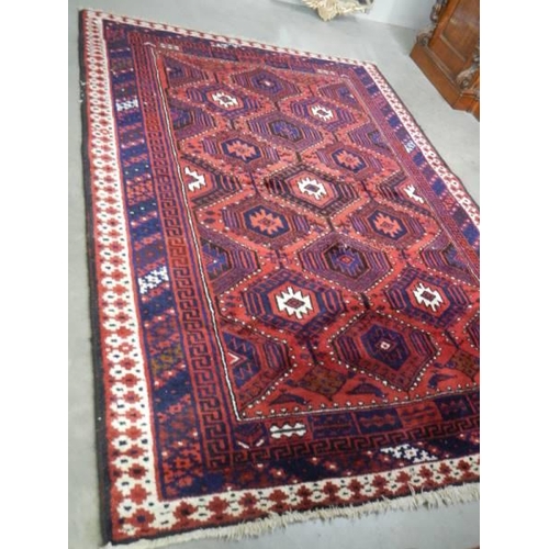 1490 - A red patterned rug 260 cm x 182 cm. COLLECT ONLY.