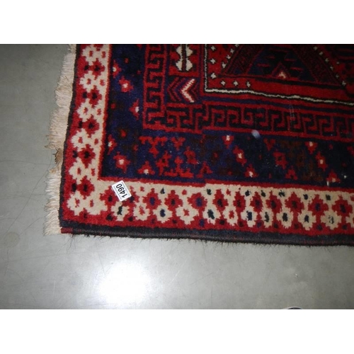 1490 - A red patterned rug 260 cm x 182 cm. COLLECT ONLY.