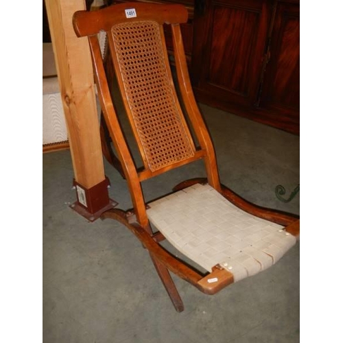 1491 - An Edwardian folding campaign chair with bergere panel, COLLECT ONLY.