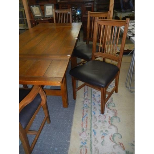 1505 - A good quality oak extending dining table with six chairs. COLLECT ONLY.