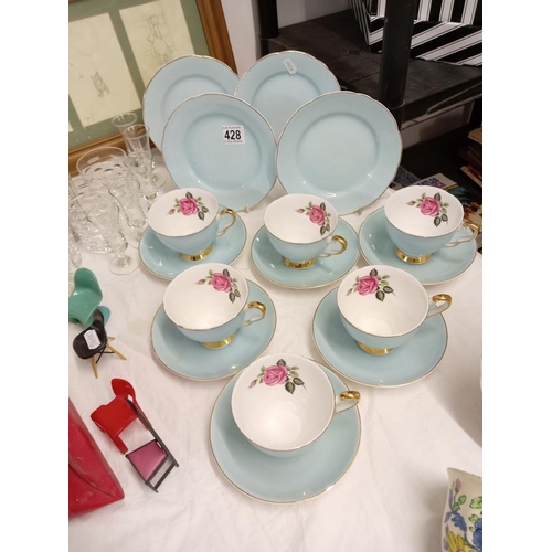 428 - A quantity of bone china cups with rose design, saucers & side plates