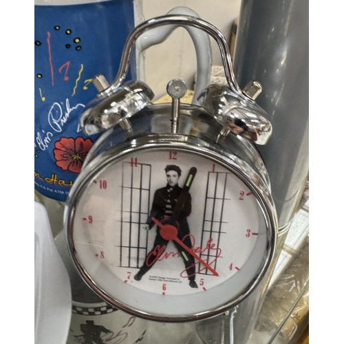 753 - A large quantity of Elvis mugs & clocks etc.