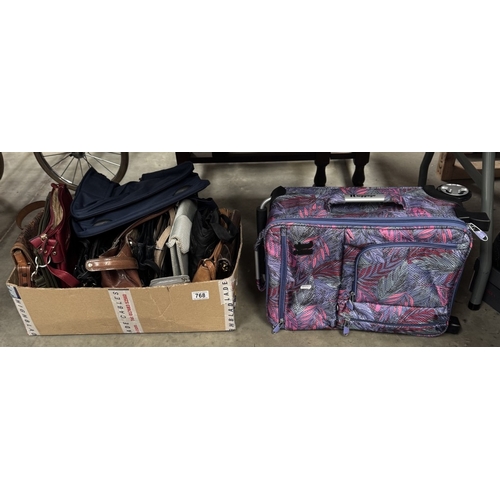 768 - A quantity of ladies handbags & a suitcase