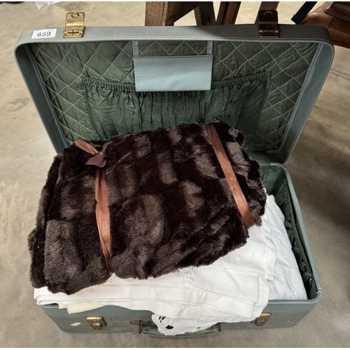 859 - A vintage suitcase of linens & a new blanket