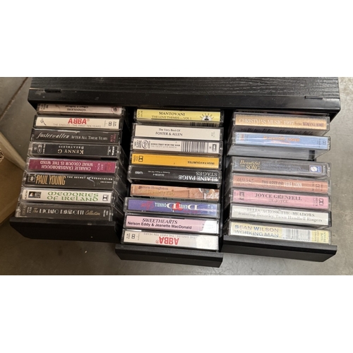 884 - A box of DVDs & a case of vintage music cassettes