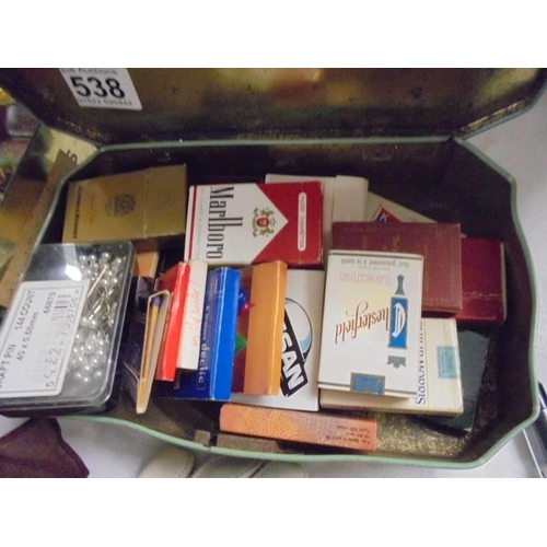 538 - A mixed lot including match books etc.,