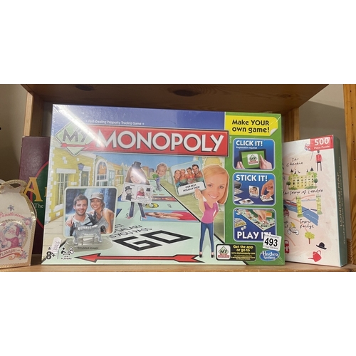 493 - A quantity of games & puzzles including a new sealed Monopoly etc (3 Shelves)