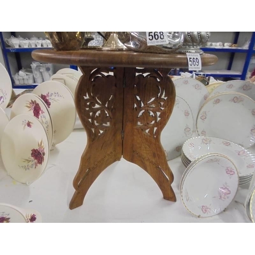 569 - A mid 20th century carved teak side table, COLLECT ONLY.