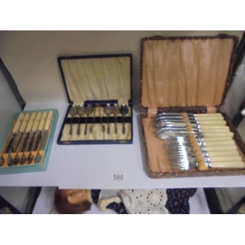 580 - Three cased sets of cutlery.