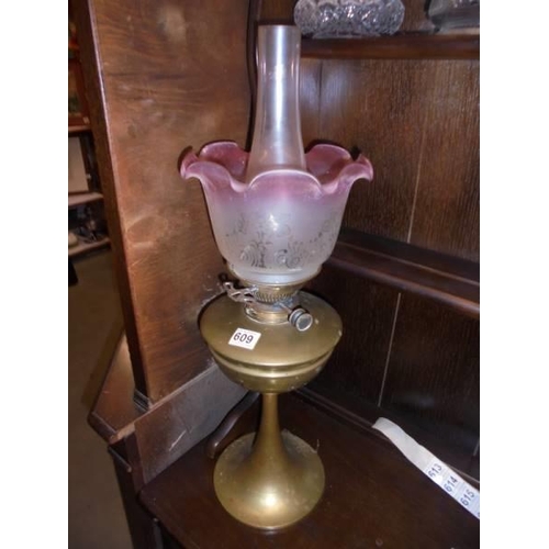 609 - A brass oil lamp with Hinks burner and tulip shade. COLLECT ONLY.