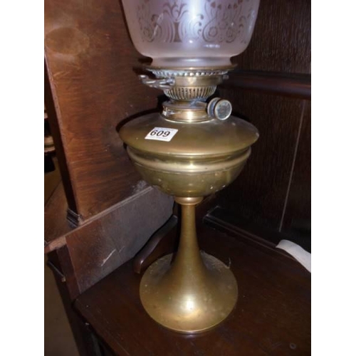 609 - A brass oil lamp with Hinks burner and tulip shade. COLLECT ONLY.