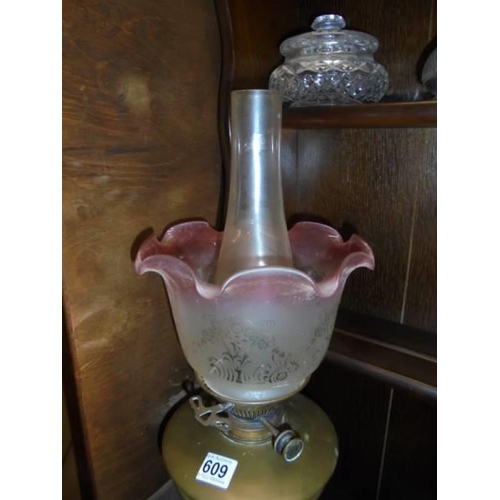 609 - A brass oil lamp with Hinks burner and tulip shade. COLLECT ONLY.