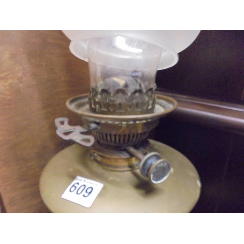 609 - A brass oil lamp with Hinks burner and tulip shade. COLLECT ONLY.