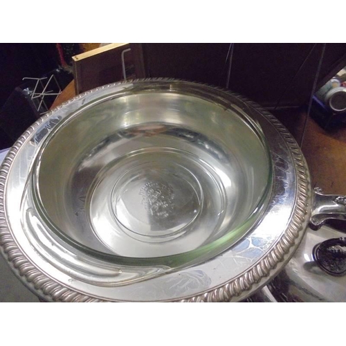 613 - A silver plate entree dish with glass liner and complete with burner.