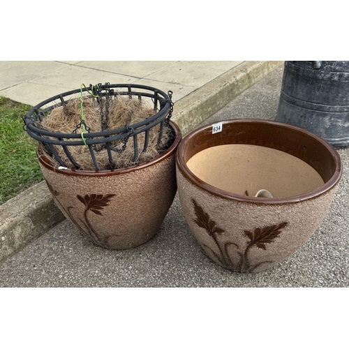 634 - 2 Large stone planters with 2 hanging basket holders