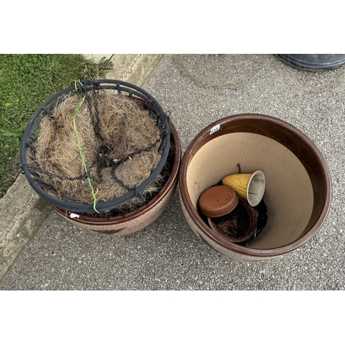 634 - 2 Large stone planters with 2 hanging basket holders