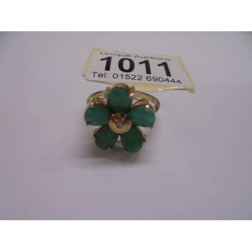 1011 - A yellow gold emerald petal ring with diamond centre, size N, 4.57 grams.