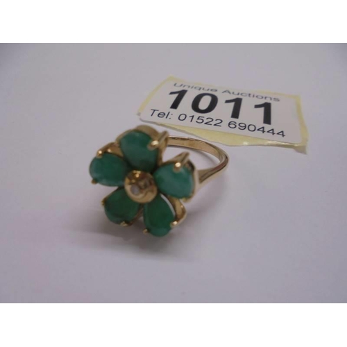 1011 - A yellow gold emerald petal ring with diamond centre, size N, 4.57 grams.