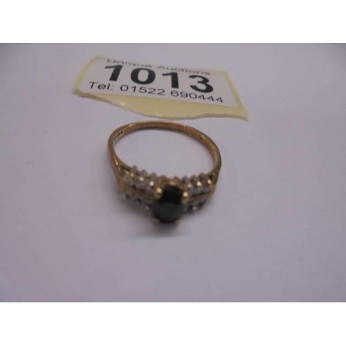 1013 - A 9ct yellow gold pinnacle sapphire side diamond ring, size O, 1.9 grams.