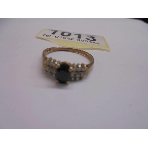 1013 - A 9ct yellow gold pinnacle sapphire side diamond ring, size O, 1.9 grams.