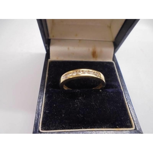 1016 - A 9ct gold half eternity ring set diamond chips, size P, 3.8 grams.