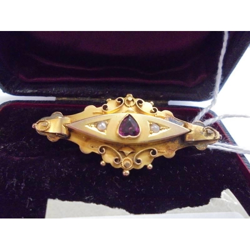 1017 - A Victorian 9ct gold brooch set amethyst and seed pearls, 5 cm wide, 3.98 grams.