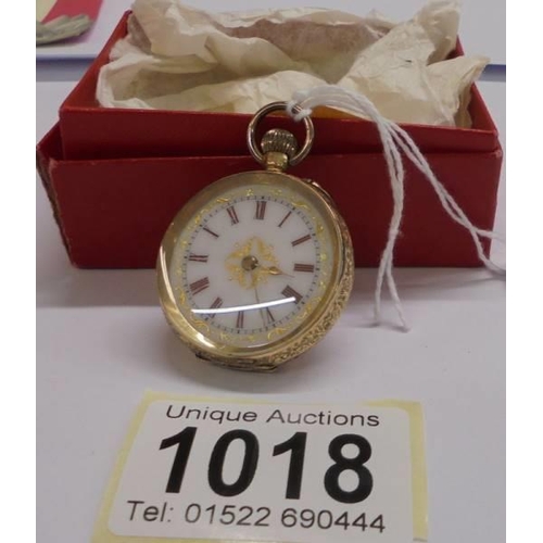 1018 - A 14ct gold cased ladies fob watch with enamelled dial, 34mm diameter, total weight 29 grams.