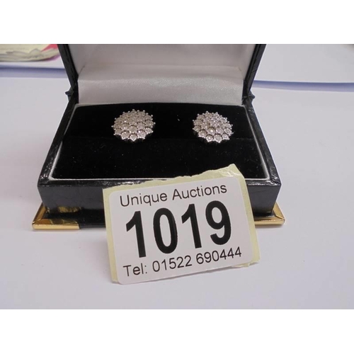 1019 - A pair of white 9ct gold fine diamond earrings, total weight 5 grams.