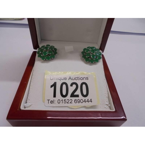 1020 - A pair of silver and emerald earrings.