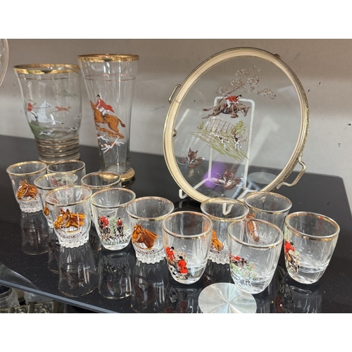 633 - A large vintage water jug & sets of glasses depicting hunting scenes