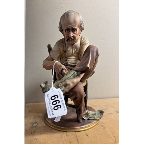 666 - A continental porcelain figure of a man darning his sock.