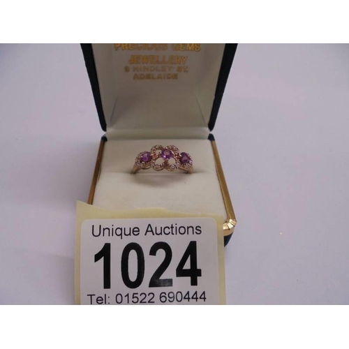 1024 - An antique style natural pink sapphire and diamond simulant rose gold plaed ring. size N.